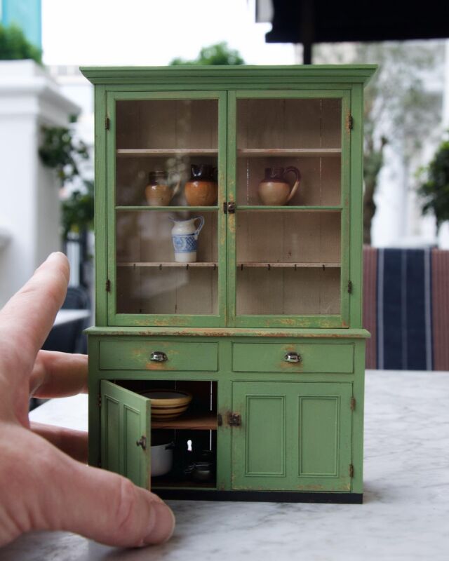 One of the pieces I made for the Kensington Dollshouse Festival was my Killarney Potboard Dresser, an Irish piece from the second half to the 19th century.

From what I understand, “potboard” refers to the lower shelf where pots and pans would be stored. These shelves get a lot of wear and dampness so often need replacing in old pieces of furniture. I aged my potboard with a blackening formula that reacts with the tannins in the wood.

Along with all of the mortise and tenon joinery, there are some wonderful details on this piece like the large panes of real glass with center dividers, and the tiny nickel-plated brass door latches. 

#craiglabenzminiatures